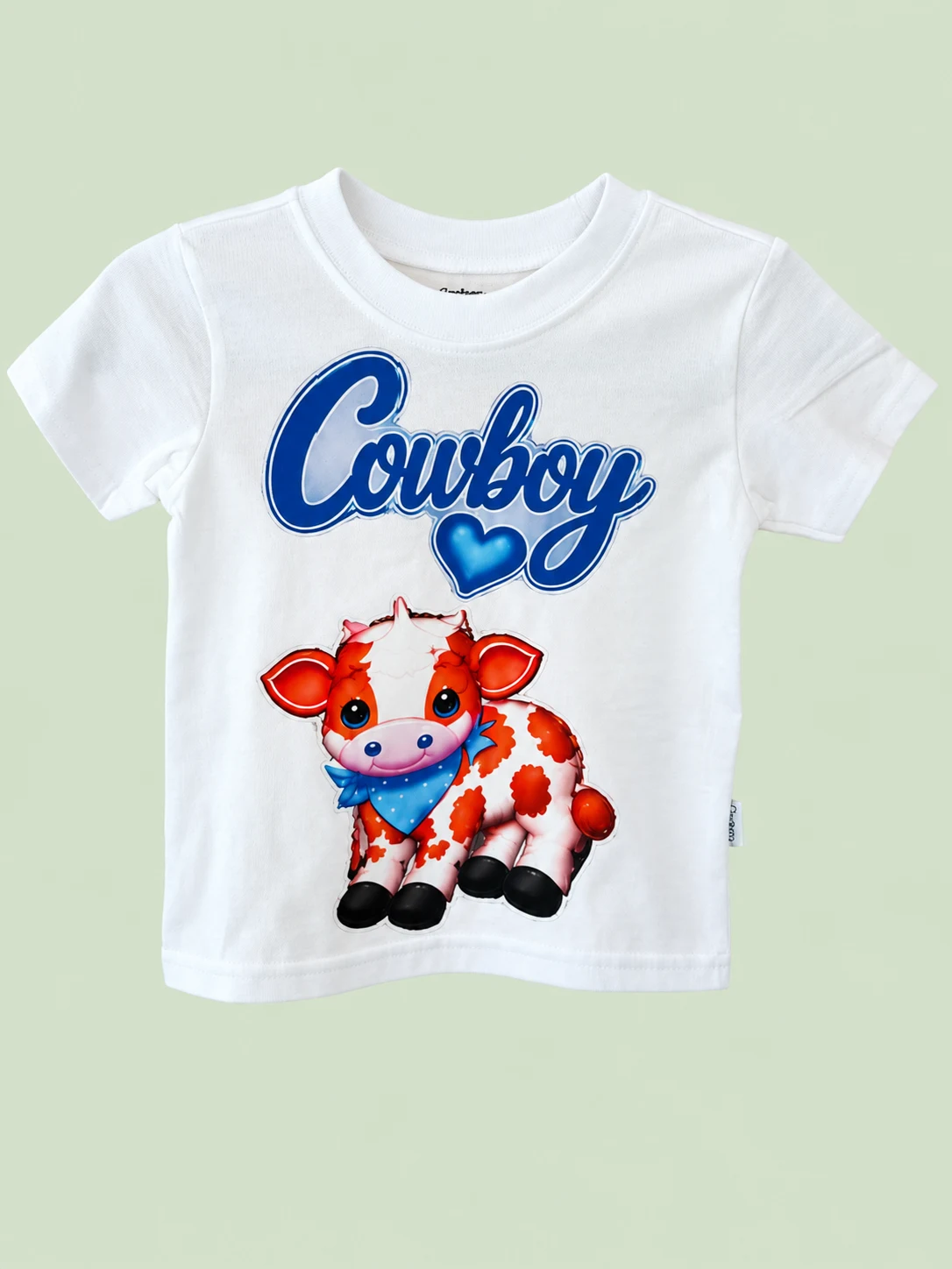 Cowboy tee on a light sage green background