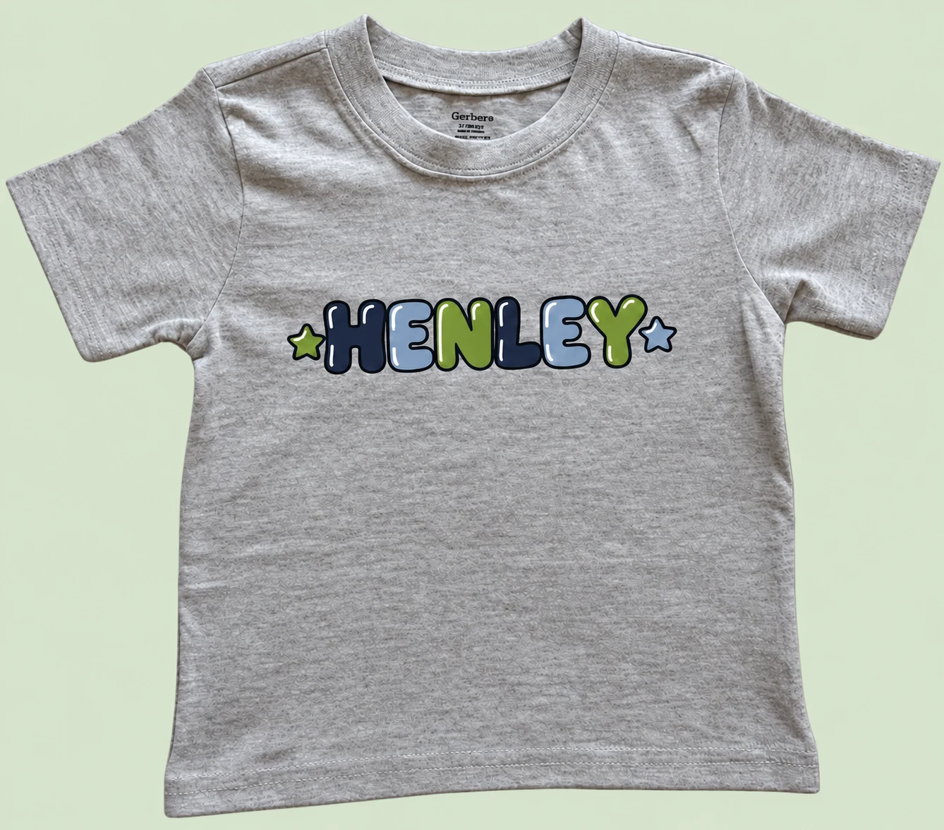 Henley personalized tee on a light sage green background